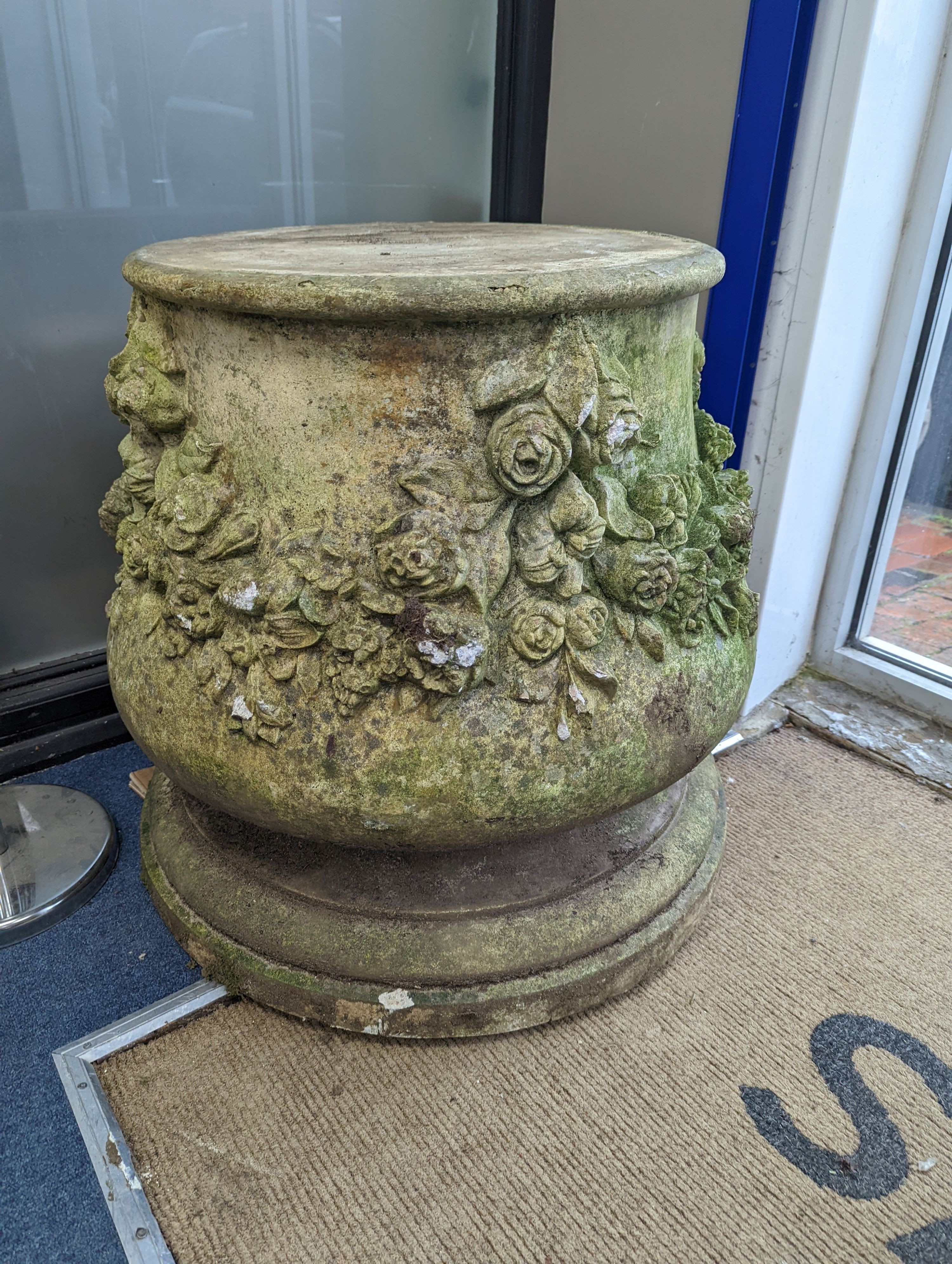 A pair of reconstituted stone garden pedestals, moulded with floral swags, height 66cm